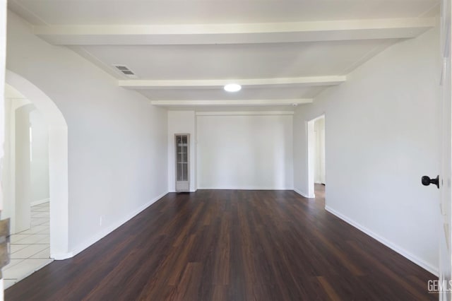 719 Washington Ave, Bakersfield, CA 93308 - spare room with beam ceiling, arched walkways, wood finished floors, and baseboards
