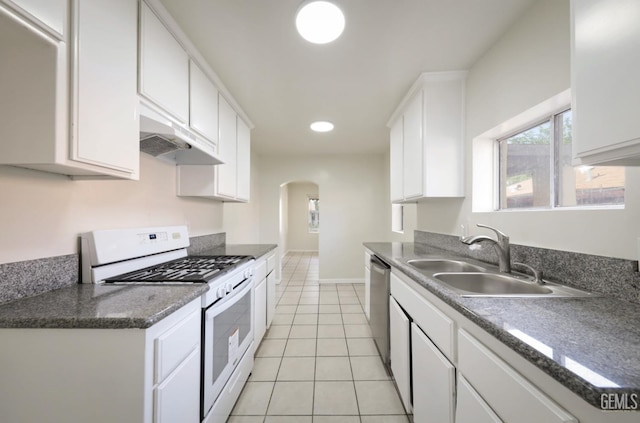 719 Washington Ave, Bakersfield, CA 93308 - kitchen with white gas range, a sink, under cabinet range hood, arched walkways, and dishwasher