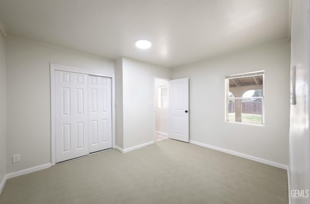 719 Washington Ave, Bakersfield, CA 93308 - unfurnished bedroom featuring carpet flooring, a closet, and baseboards