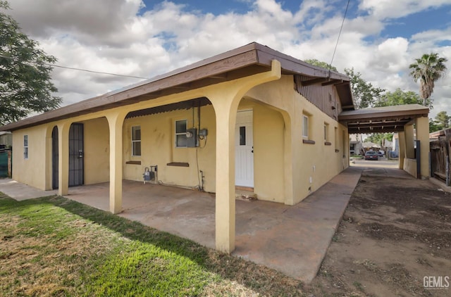 719 Washington Ave, Bakersfield, CA 93308 - view of home's exterior featuring a carport and stucco siding