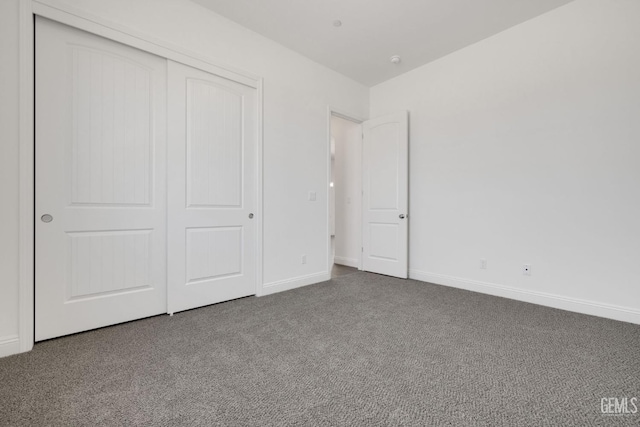 unfurnished bedroom featuring a closet and carpet flooring