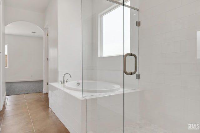 bathroom featuring plus walk in shower and tile patterned floors