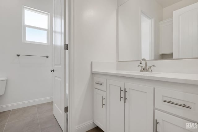 bathroom featuring tile patterned flooring, vanity, and toilet