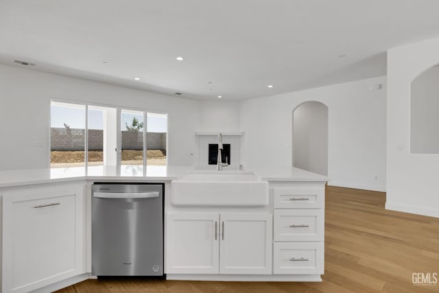 kitchen with white cabinetry, dishwasher, sink, and light hardwood / wood-style flooring