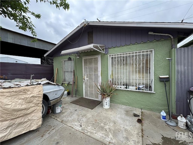 exterior space featuring a patio area and stucco siding
