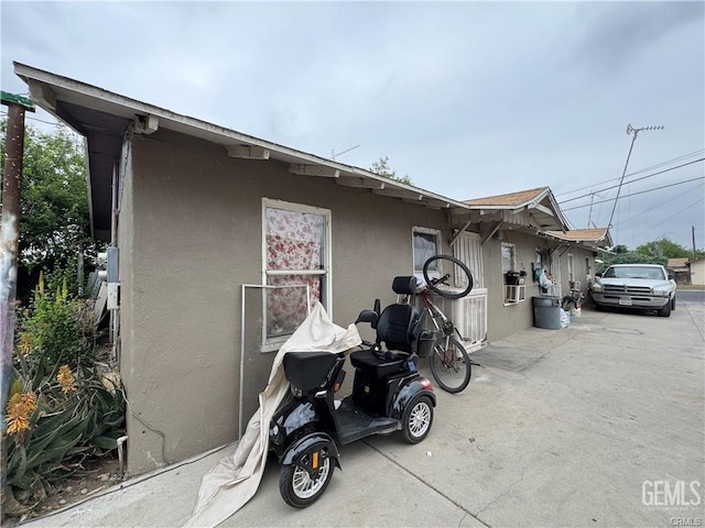 view of side of property featuring stucco siding