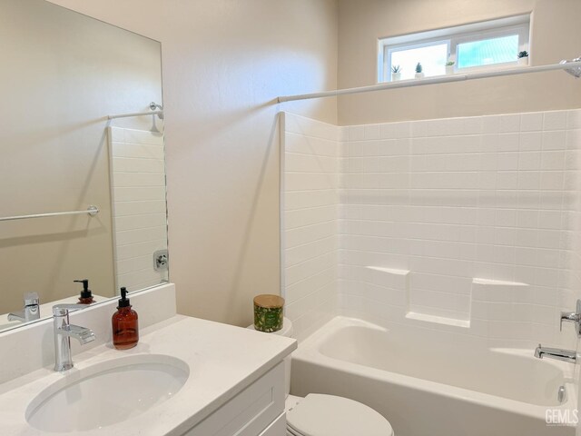 full bathroom featuring washtub / shower combination, vanity, and toilet