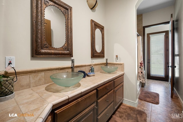 bathroom with tile patterned floors and vanity