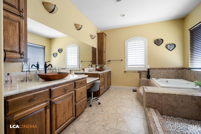 bathroom with tile patterned flooring, vanity, and a wealth of natural light