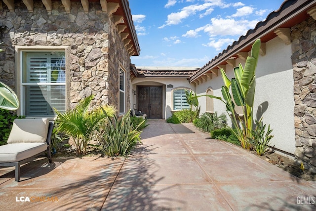 entrance to property with a patio