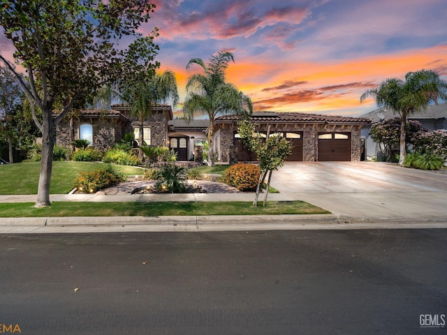 mediterranean / spanish home with a garage