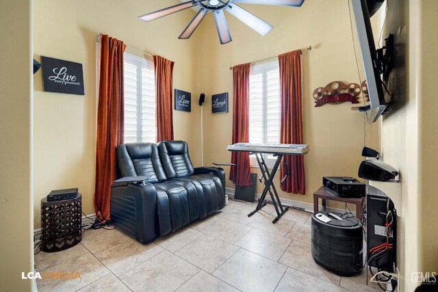 living area featuring light tile patterned floors and ceiling fan