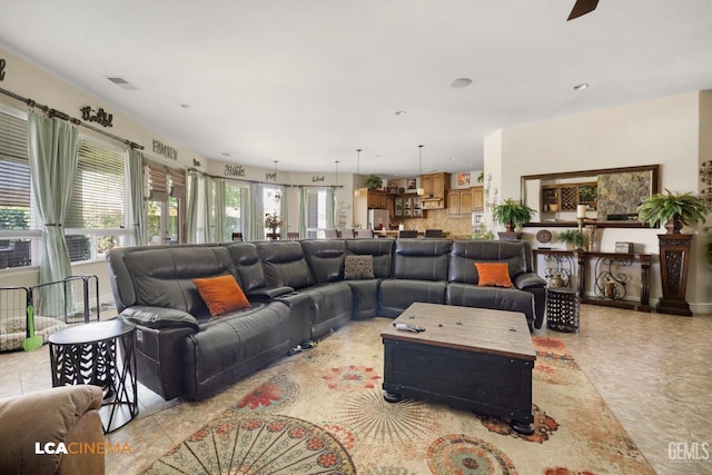 tiled living room featuring ceiling fan