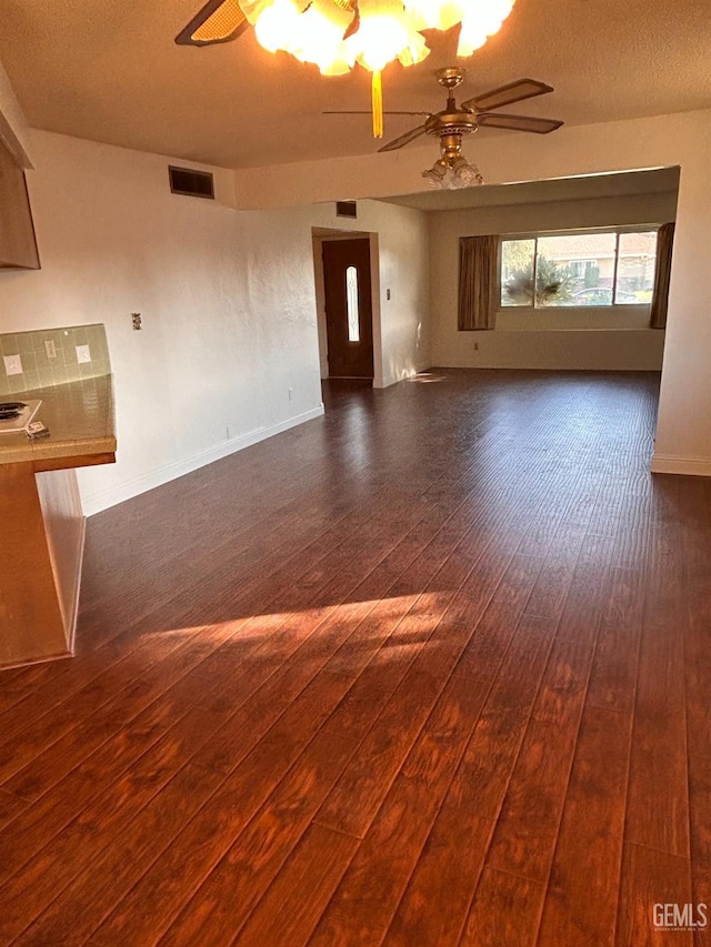 spare room featuring dark hardwood / wood-style floors and ceiling fan