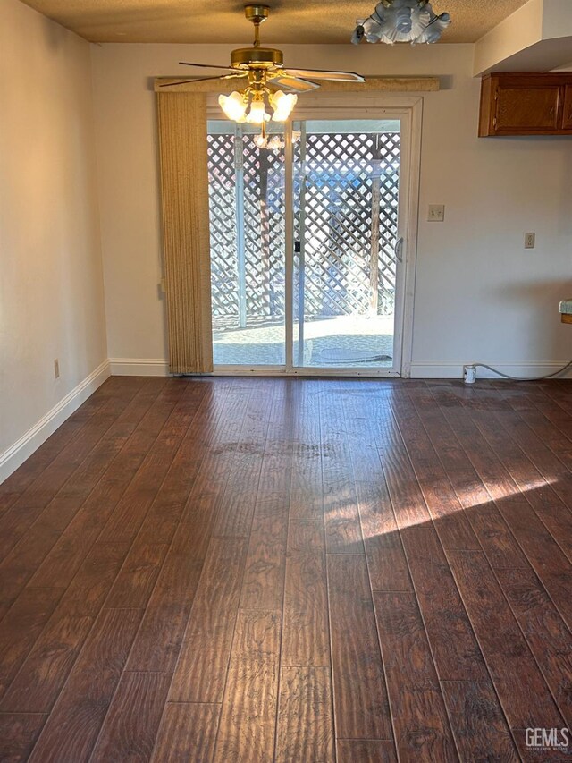 spare room with ceiling fan and dark wood-type flooring