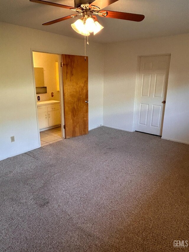 unfurnished bedroom with ensuite bathroom, ceiling fan, and light colored carpet