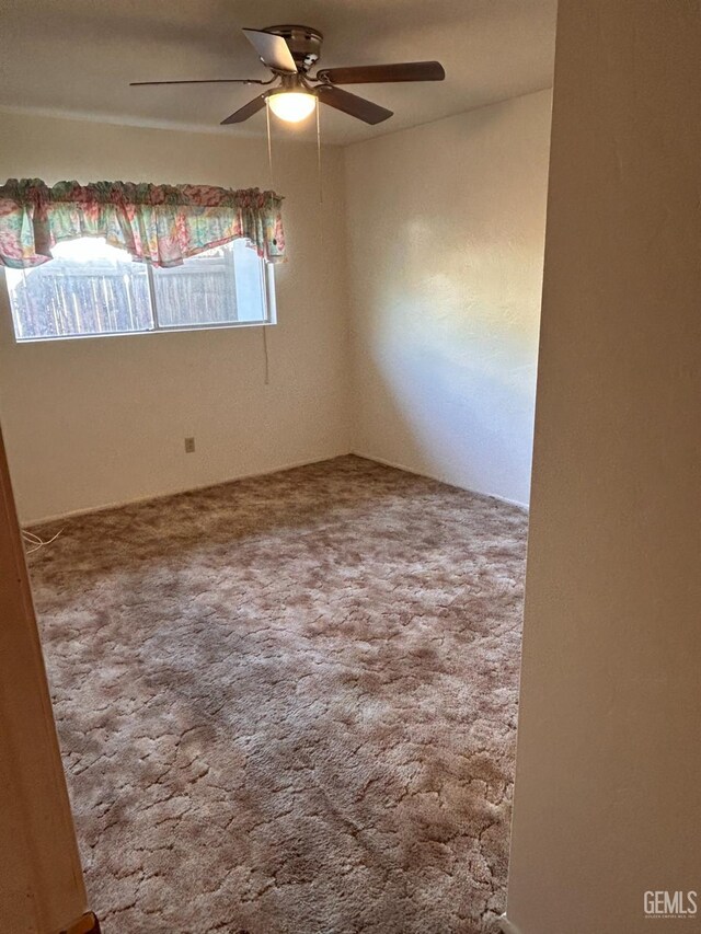 spare room featuring carpet flooring and ceiling fan