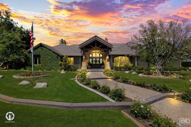 view of front of home featuring french doors and a yard