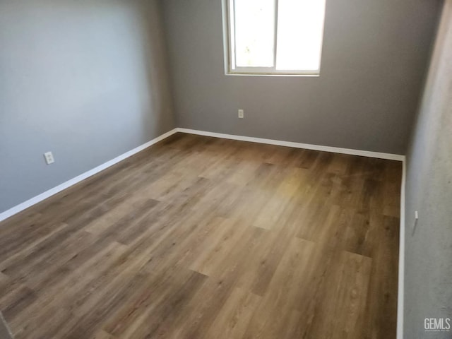 spare room with hardwood / wood-style flooring