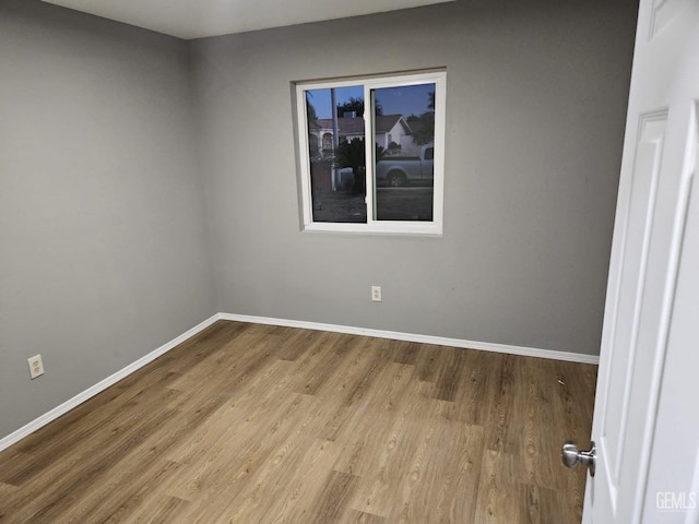 empty room with wood-type flooring