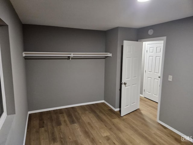 unfurnished bedroom with hardwood / wood-style flooring