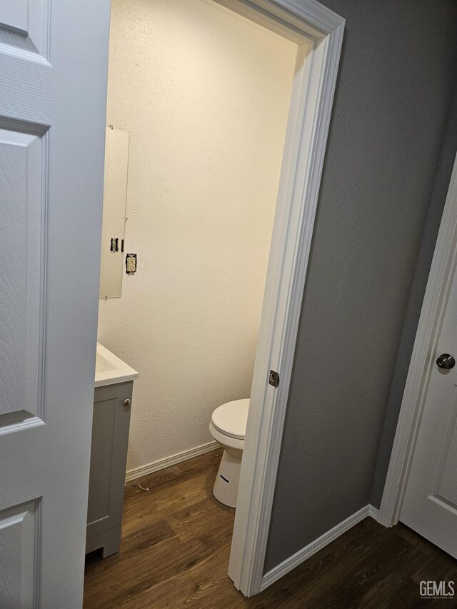 full bathroom featuring hardwood / wood-style flooring, vanity, toilet, and tiled shower / bath combo