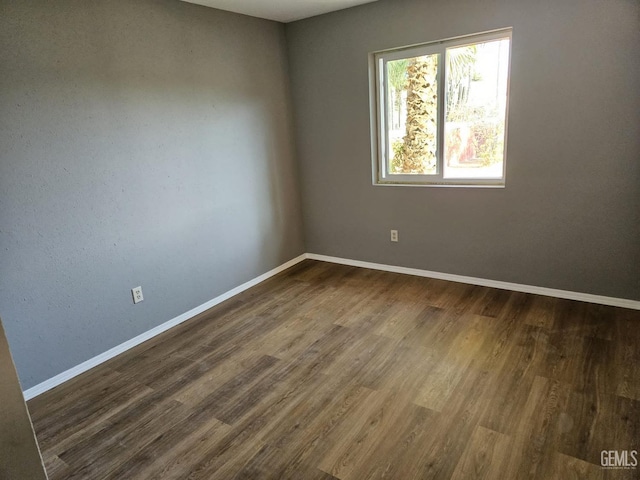 empty room with dark wood-type flooring