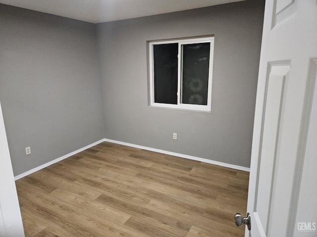 empty room with light hardwood / wood-style flooring