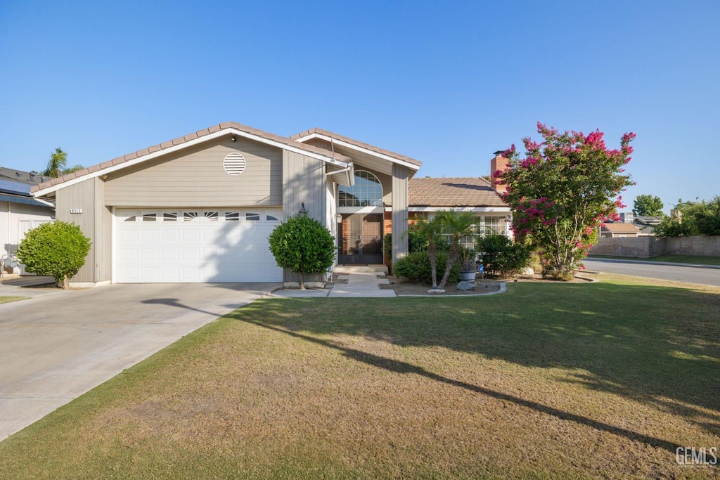 9313 Seager Ct, Bakersfield, CA 93311 - ranch-style home with a tile roof, an attached garage, a front lawn, and driveway