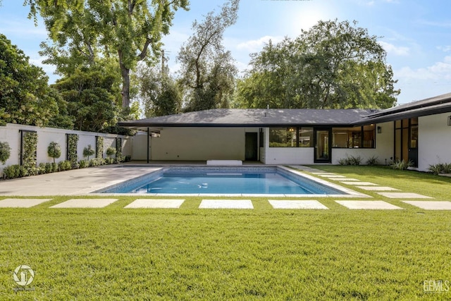 view of pool featuring a yard and a patio