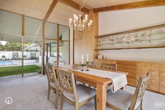 dining space with wood walls, wood ceiling, beam ceiling, and light carpet