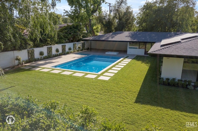 view of pool featuring a patio area and a yard