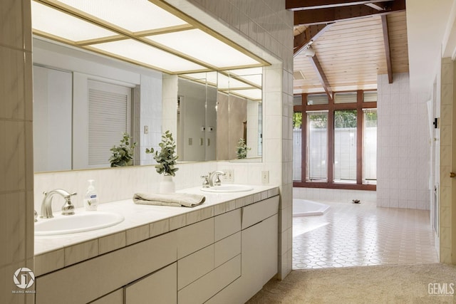 bathroom with tile patterned flooring, vanity, and tile walls