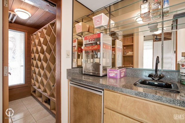 bar featuring light tile patterned floors, wood ceiling, and sink