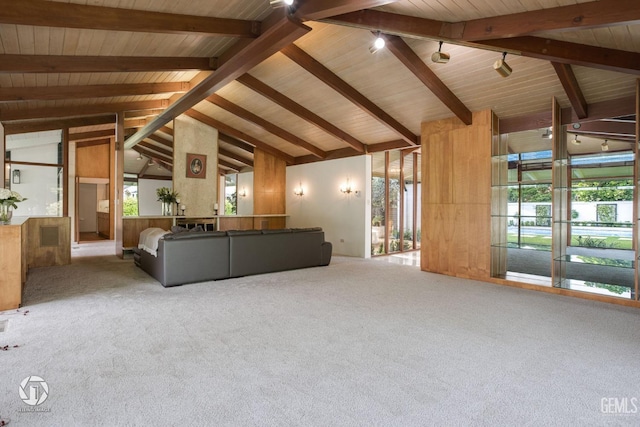 unfurnished living room with beamed ceiling, carpet, high vaulted ceiling, and wooden ceiling