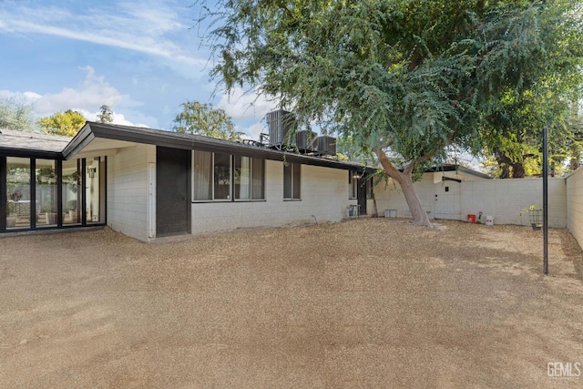 rear view of property featuring central AC unit