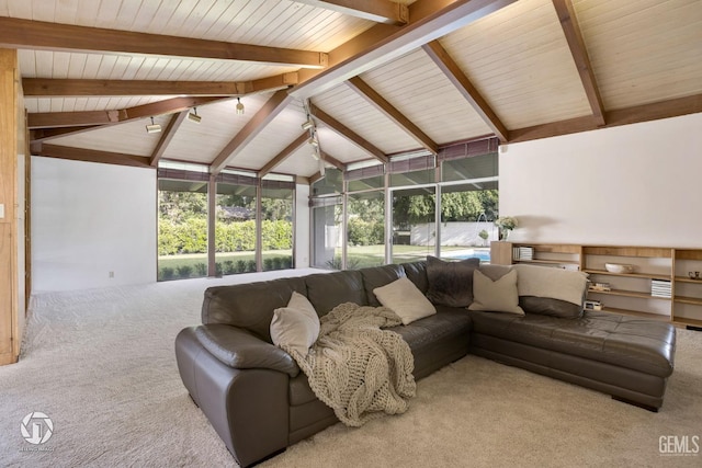 living room featuring vaulted ceiling with beams and carpet floors