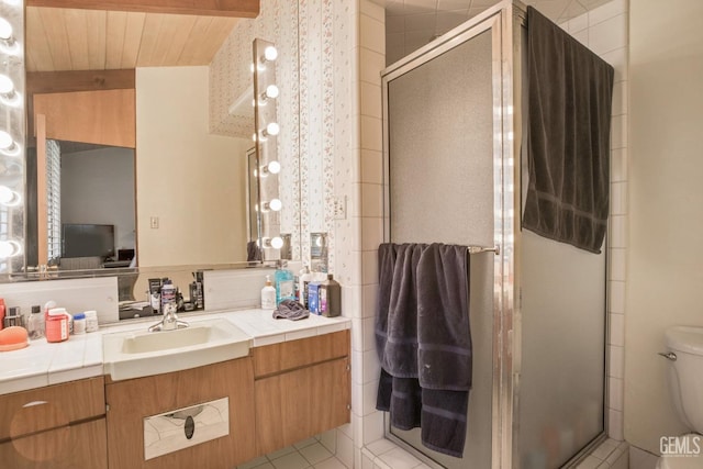 bathroom with lofted ceiling with beams, tile patterned floors, toilet, a shower with door, and vanity