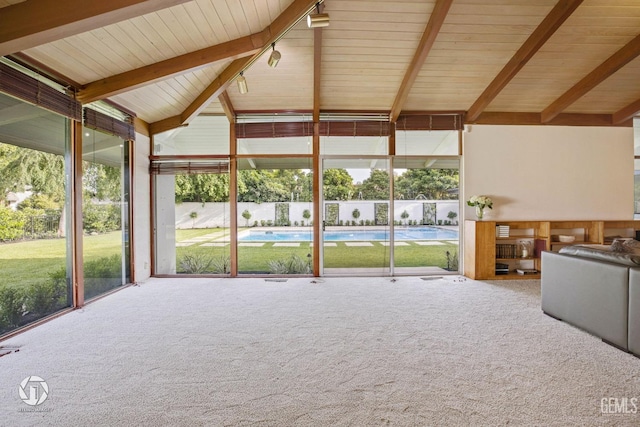 unfurnished sunroom with vaulted ceiling with beams