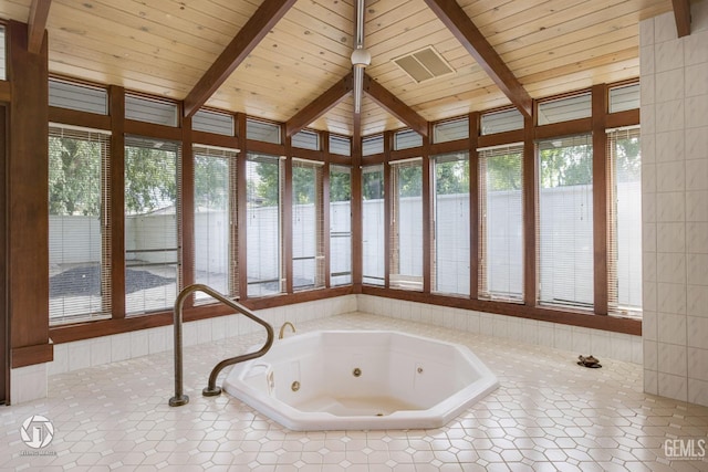 unfurnished sunroom featuring lofted ceiling with beams and wooden ceiling