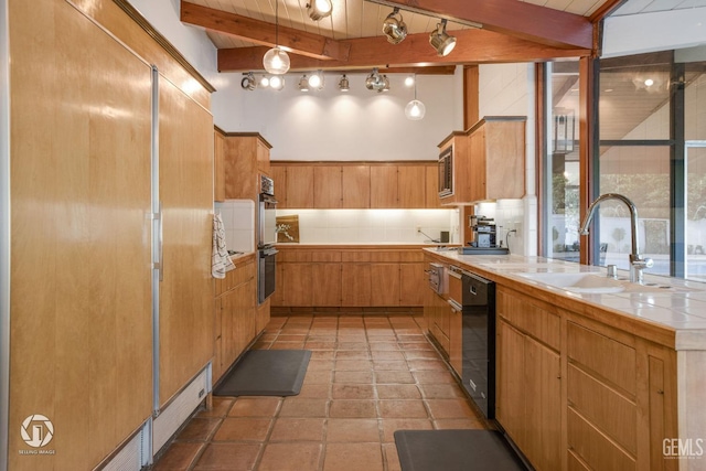 kitchen featuring hanging light fixtures, sink, beam ceiling, dishwasher, and tile counters