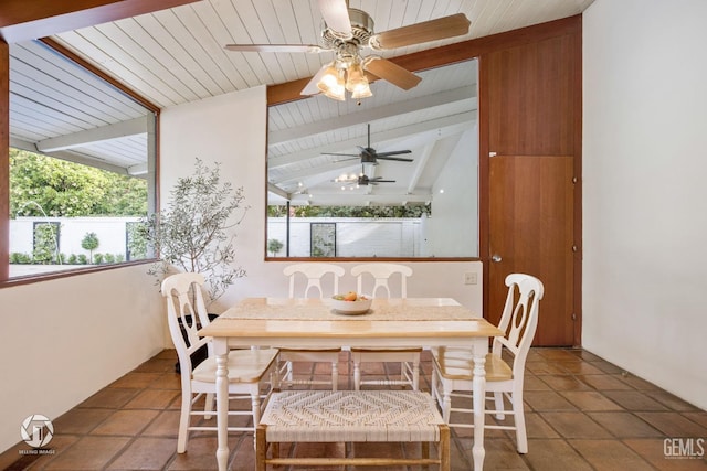 dining area with vaulted ceiling with beams, ceiling fan, tile patterned flooring, and wood ceiling