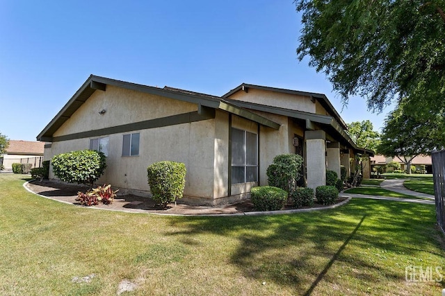800 Lexington St Unit 28, Delano, CA 93215 - view of side of property with stucco siding and a lawn