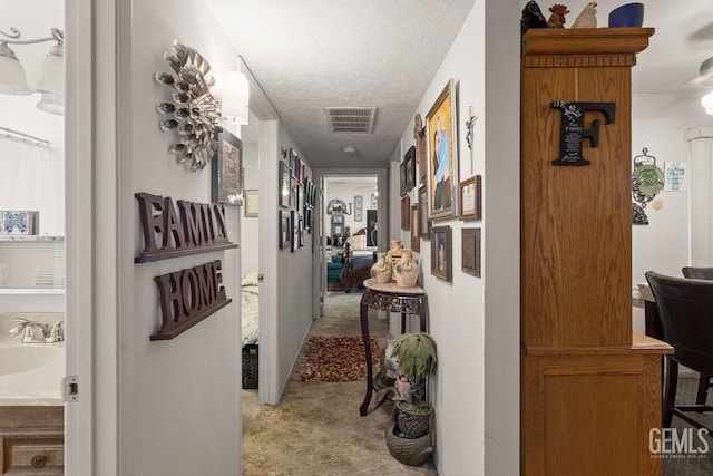 800 Lexington St Unit 28, Delano, CA 93215 - hallway featuring light carpet and a textured ceiling