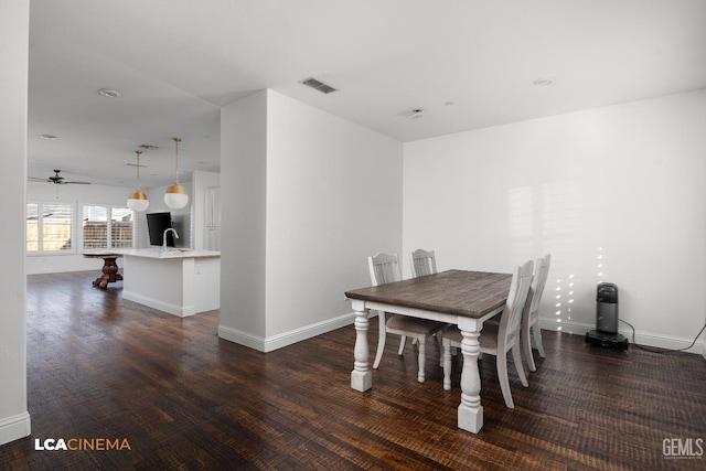 3303 Rustic Woods Ln, Shafter, CA 93263 - dining area featuring dark wood-style floors, baseboards, and a ceiling fan