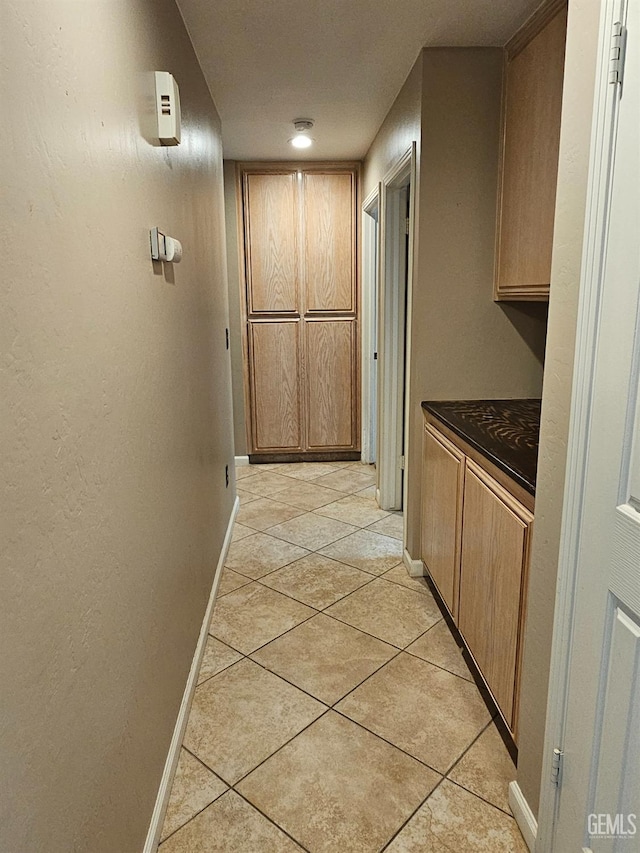 hallway with light tile patterned floors