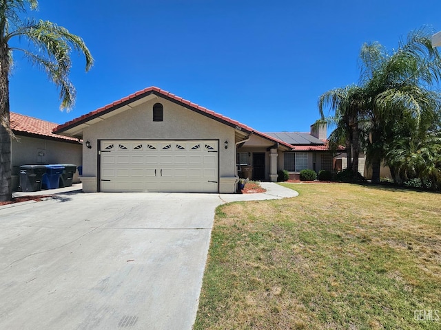 view of front of house with solar panels, a front lawn, and a garage