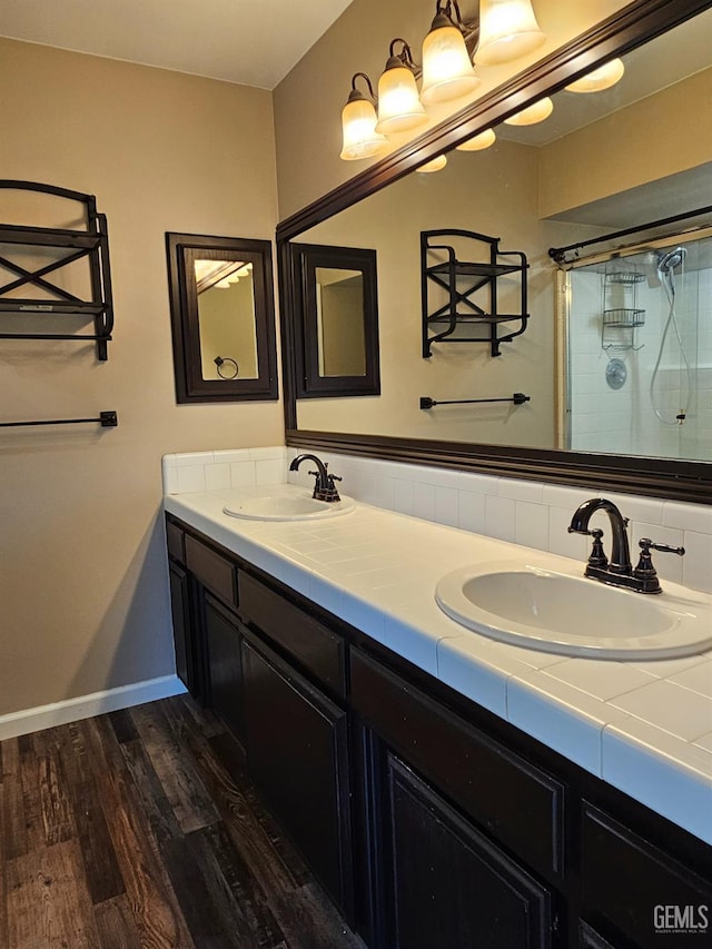 bathroom with an enclosed shower, vanity, and hardwood / wood-style flooring