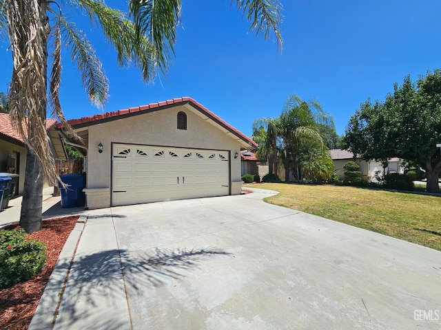 view of side of home with a lawn and a garage