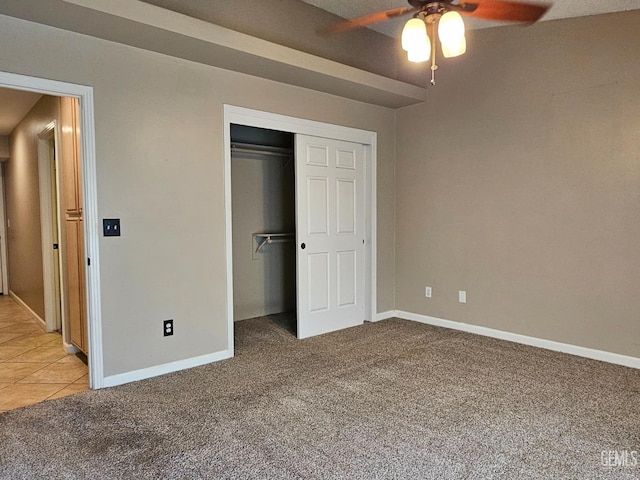 unfurnished bedroom with a closet, ceiling fan, and light colored carpet